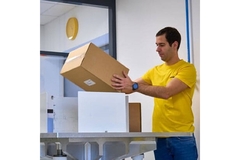 Image Man holding paper box for e-commerce.